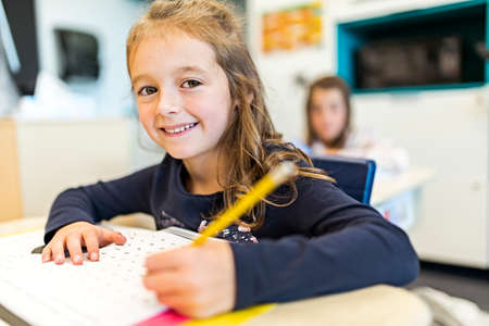 education and school concept little student girl studying at school