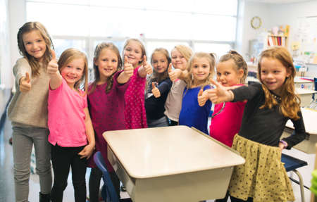 education and school concept little student girl studying at schoolの写真素材