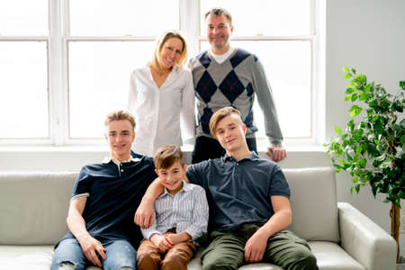 A Beautiful happy family sit on sofa at home