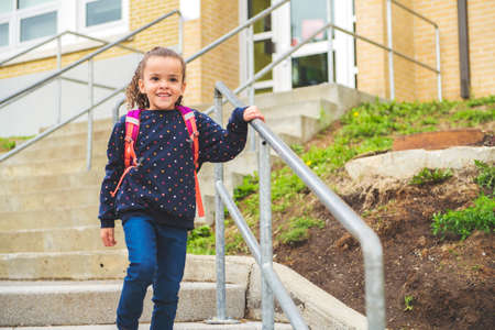 A nice Portrait of cute hispanic girl with backpack at school
