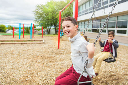 the boys on the playground swing on the school day