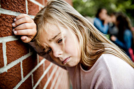 sad intimidation moment Elementary Age Bullying in Schoolyardの写真素材