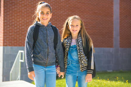 Two kids on the school background having fun