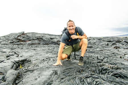 The man Tourist visiting the lava field at hawaii