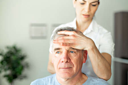 A Modern rehabilitation physiotherapy worker with senior client
