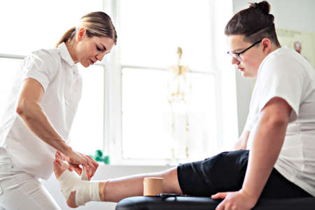 A Modern rehabilitation physiotherapy woman worker with client