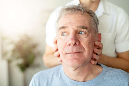 A Modern rehabilitation physiotherapy worker with senior client