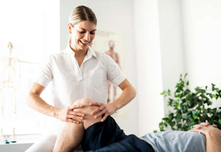 A Modern rehabilitation physiotherapy worker with senior client