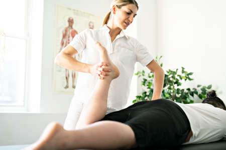 A Modern rehabilitation physiotherapy woman worker with client