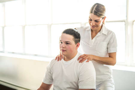 A Modern rehabilitation physiotherapy woman worker with client