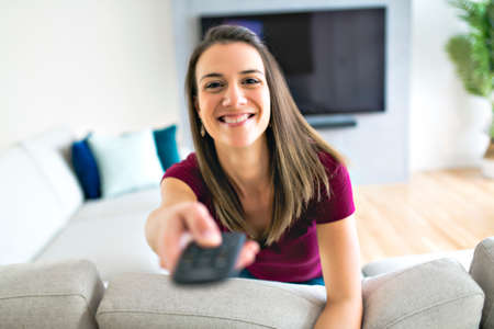 Brunette having good time on the living room watching tv