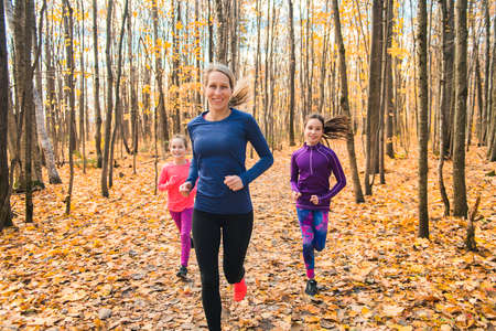 Healthy lifestyle mother and child running outdoorの写真素材