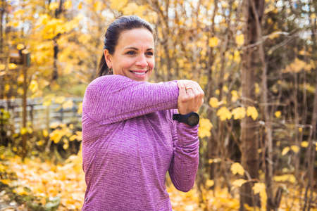 A running woman jogging in autumn nature