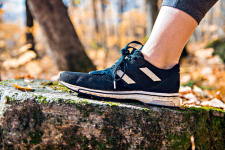 Running sport concept .Closeup of woman barefoot runner shoes. Female jogging on autumn