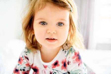 A child girl having fun on bedroomの写真素材