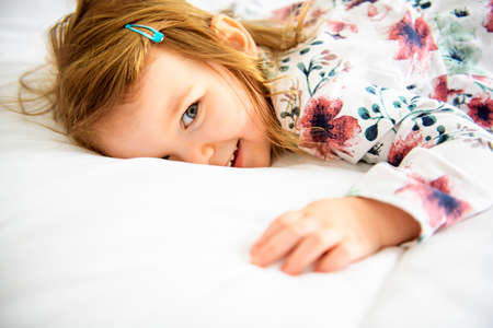 A child girl having fun on bedroomの写真素材