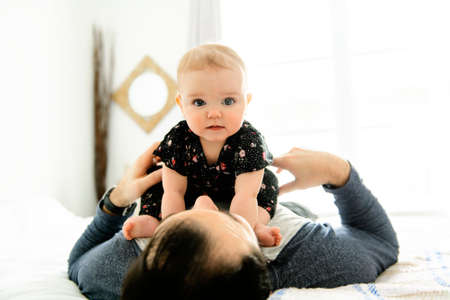 A Nice father with baby on bedの写真素材