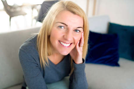 Relaxed woman enjoying rest on comfortable sofa, calm attractive girl relaxing on couch