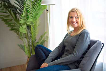 Relaxed woman enjoying rest on comfortable sofa, calm attractive girl relaxing on couch