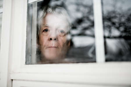A sad lonely 70 years old senior in is apartmentの写真素材