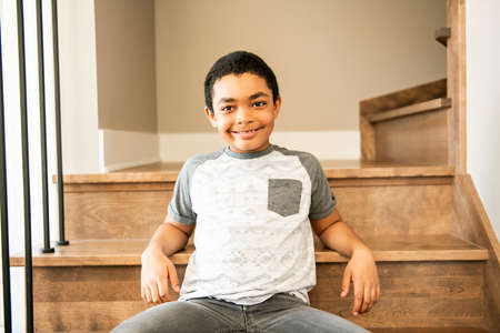 A Portrait Of african american at home sit on stairsの写真素材