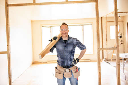 A man worker in the carpenter workroom renovation wolding wood