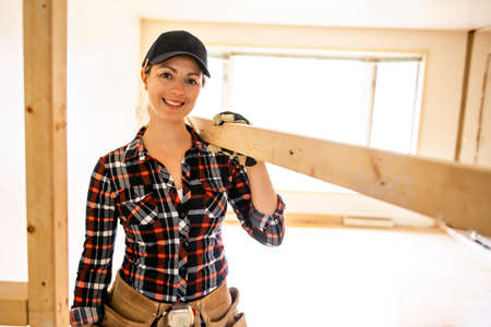 A woman worker in the carpenter workroom renovation