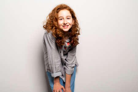 Beautiful readhead girl with on studio white backgroundの写真素材