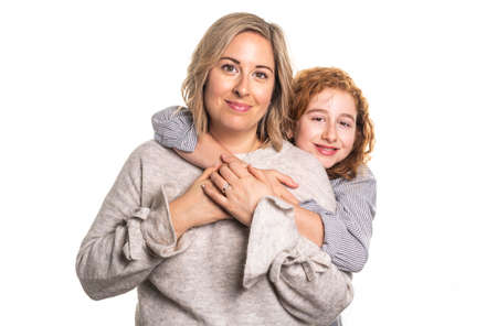Beautiful readhead girl with on studio white background with her motherの写真素材