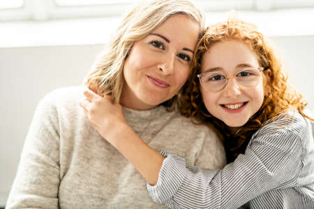 mother and daughter having good time in the living room