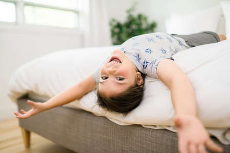A Portrait of little girl on bed in early morningの写真素材