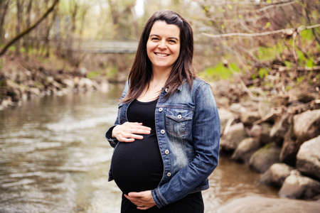 beautiful portrait of pregnant woman in natureの写真素材