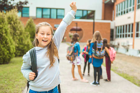 A student school girl on the playground on the first day of classの写真素材