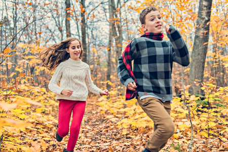 portrait of two child brother and sister in the autumn season outsideの写真素材