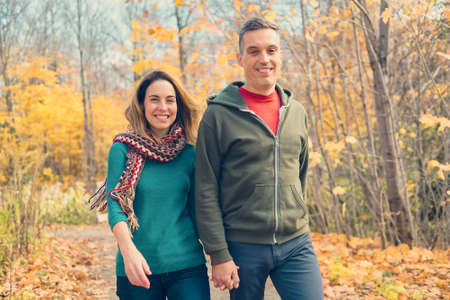 happy autumn fall couple in a park