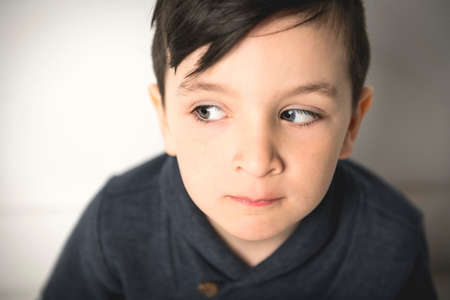 close portrait of a five years old boy over white