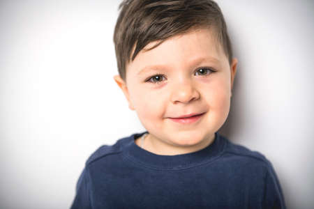 close portrait of a four years old boy over white