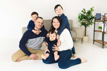young family at home with the child sit on sofa