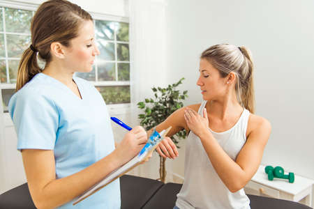 A Modern rehabilitation physiotherapist at work with client