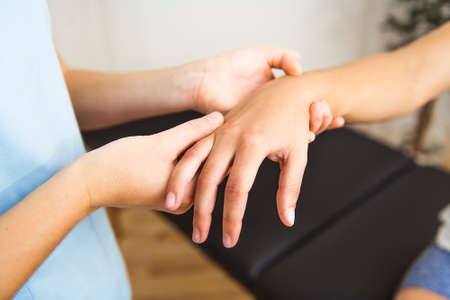 A Modern rehabilitation physiotherapist at work with clientの写真素材