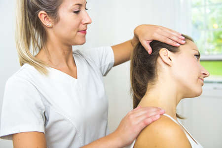 A Modern rehabilitation physiotherapist at work with clientの写真素材
