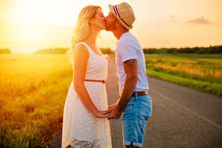 happy couple at sunset. Man and woman having fun playing in nature