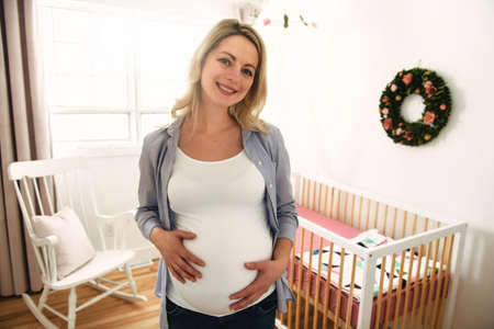 Young and happy pregnant woman expecting a babyの写真素材