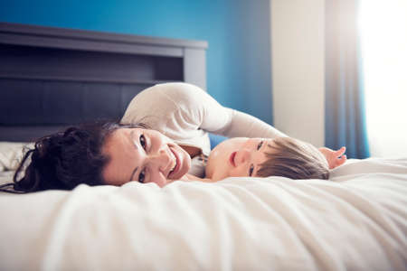 Mother and her son child taking good time on bed