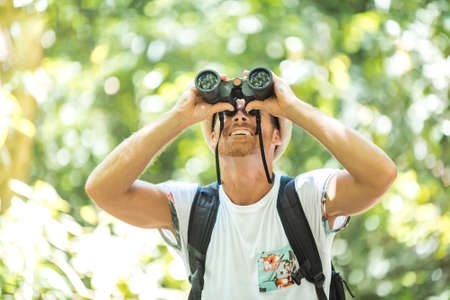 Tourist with Binoculars Looking for somethingの写真素材