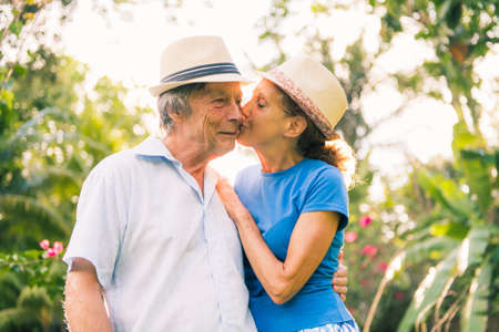 Portrait of a beautiful elderly couple standing embracing outdoors