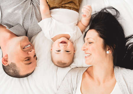 Lovely happy family in the bedroom, shot from top