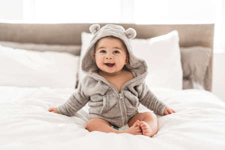 Portrait of a baby boy on the bed in bedroom