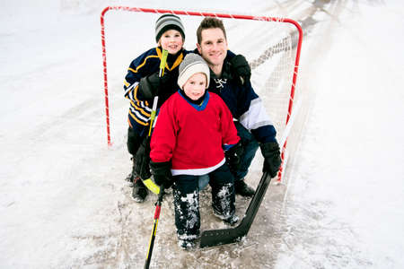 Father and son have fun playing hockey
