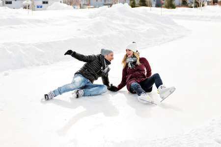couple in sunny winter nature ice skating